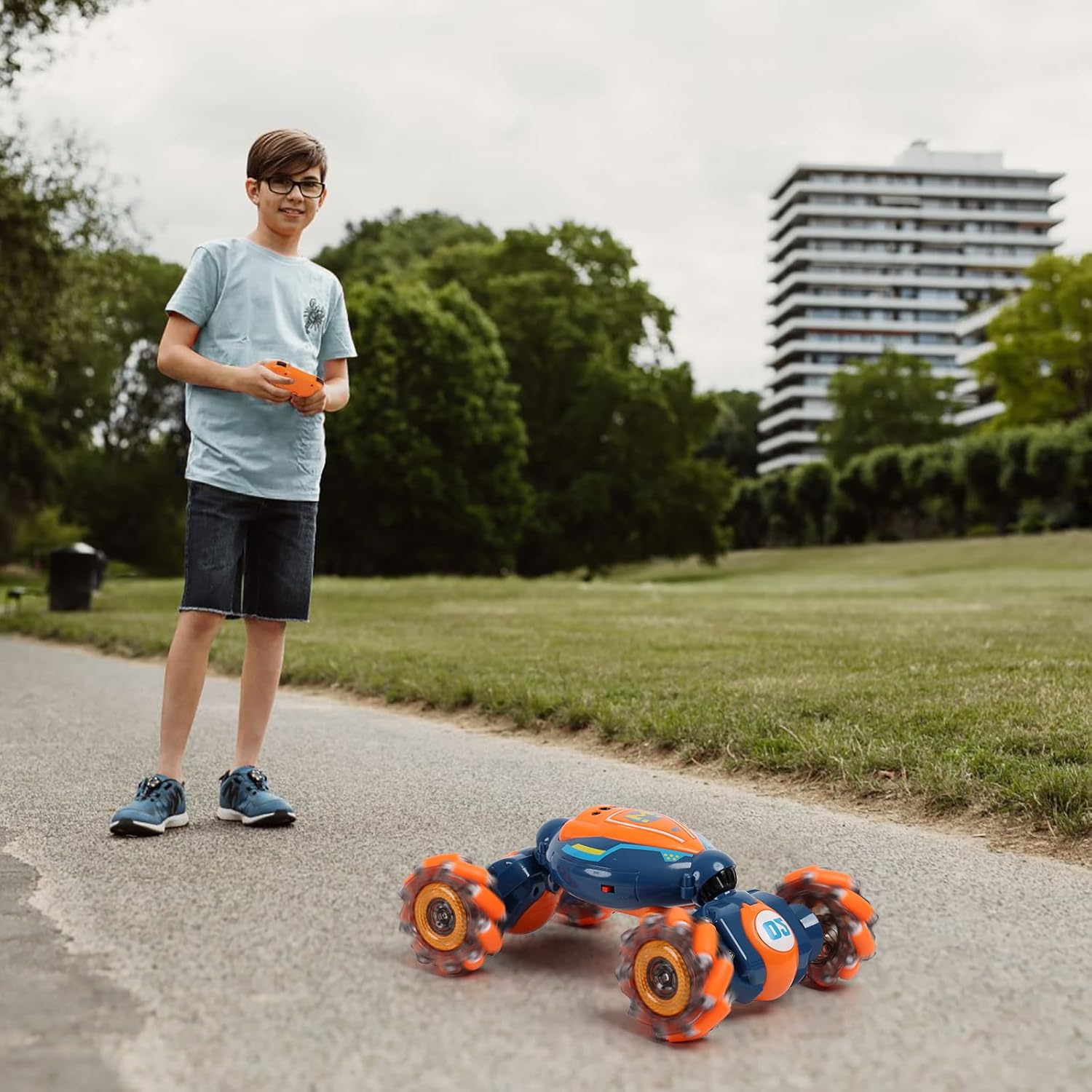 Young boy playing outdoors with the QXHOL Gesture-Sensing Stunt Car, enjoying its dynamic features on a smooth road